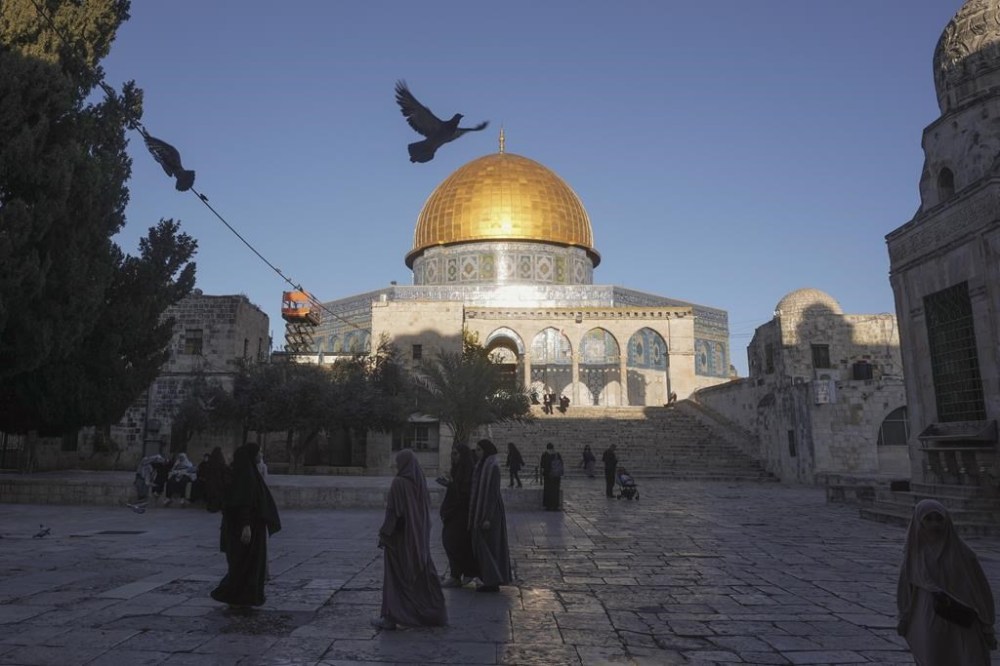 FILE - Muslims walk next to the Dome of Rock Mosque at the Al-Aqsa Mosque compound in Jerusalem's Old City, March 10, 2024. Israeli lawmaker Itamar Ben-Gvir visited Al-Aqsa Mosque compound Thursday, July 18, 2024, a move that could threaten the delicate Gaza cease-fire talks. (AP Photo/Mahmoud Illean, File)