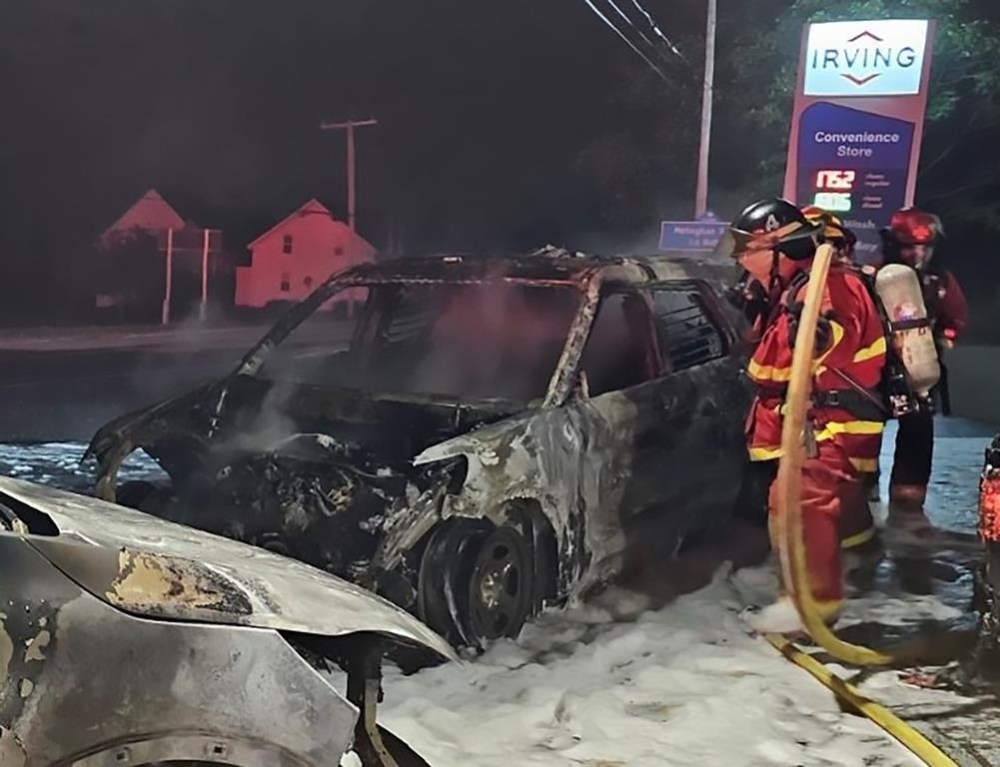 Fire crews respond after an RCMP cruiser was set on fire in Meteghan, N.S., in this recent handout photo. THE CANADIAN PRESS/HO - RCMP