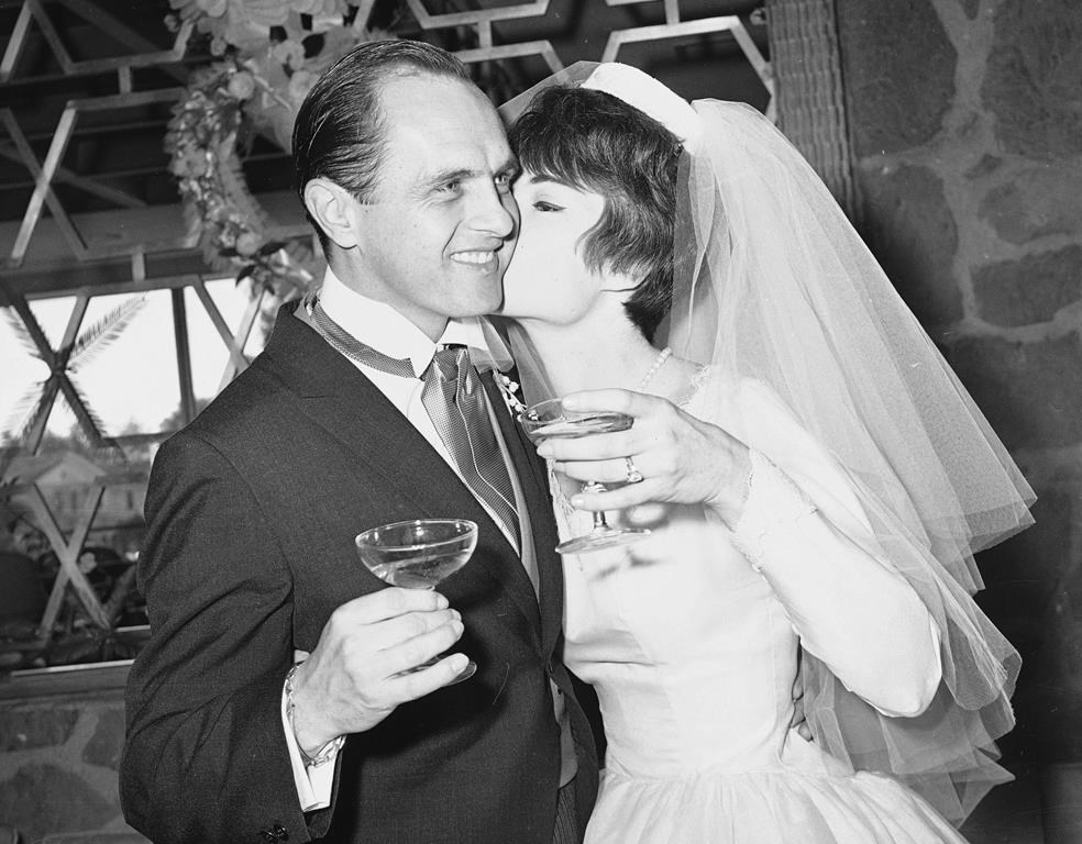 FILE - Comedian Bob Newhart, 33, and his bride Virginia Quinn, 22, kiss during toast at a reception that followed their marriage in St. Victor Roman Catholic Church in West Hollywood, Calif. on Jan. 12, 1963. Newhart, the deadpan master of sitcoms and telephone monologues, died in Los Angeles on Thursday, July 18, 2024. He was 94. (AP Photo/David Smith, File)