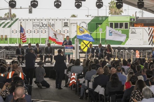 US Secretary of Transportation Pete Buttigieg, at podium, addresses a groundbreaking ceremony of a $1.5 billion rail project dubbed 