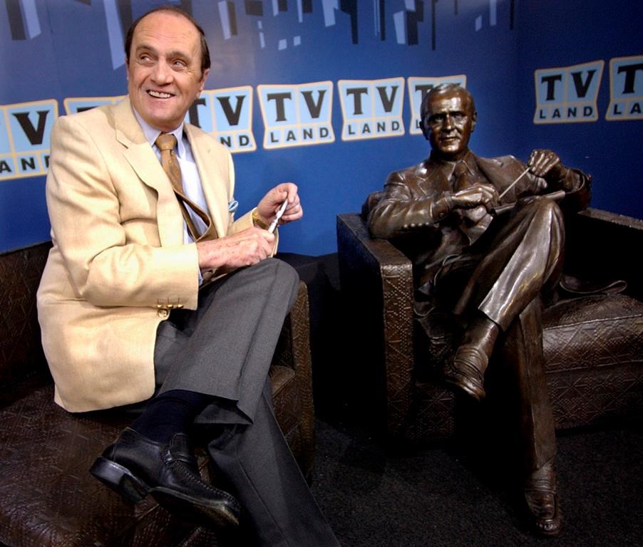 FILE - Actor-comedian Bob Newhart sits with a bronze likeness of Dr. Bob Hartley, the character he played in the 1972-78 sitcom