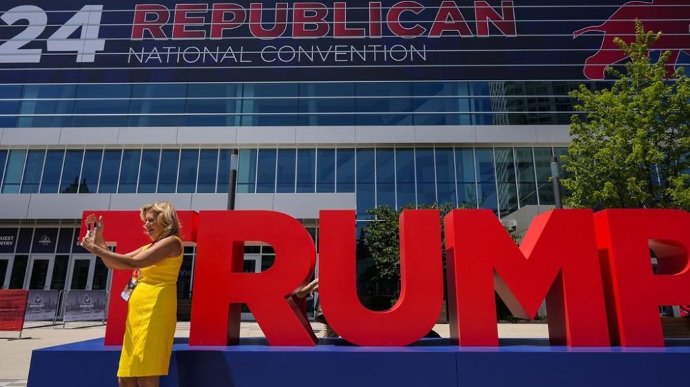 Arizona Delegate Kathleen Winn takes a photo outside the Fiserv Forum during the final day of the 2024 Republican National Convention, Thursday, July 18, 2024, in Milwaukee. (AP Photo/Mike Stewart)