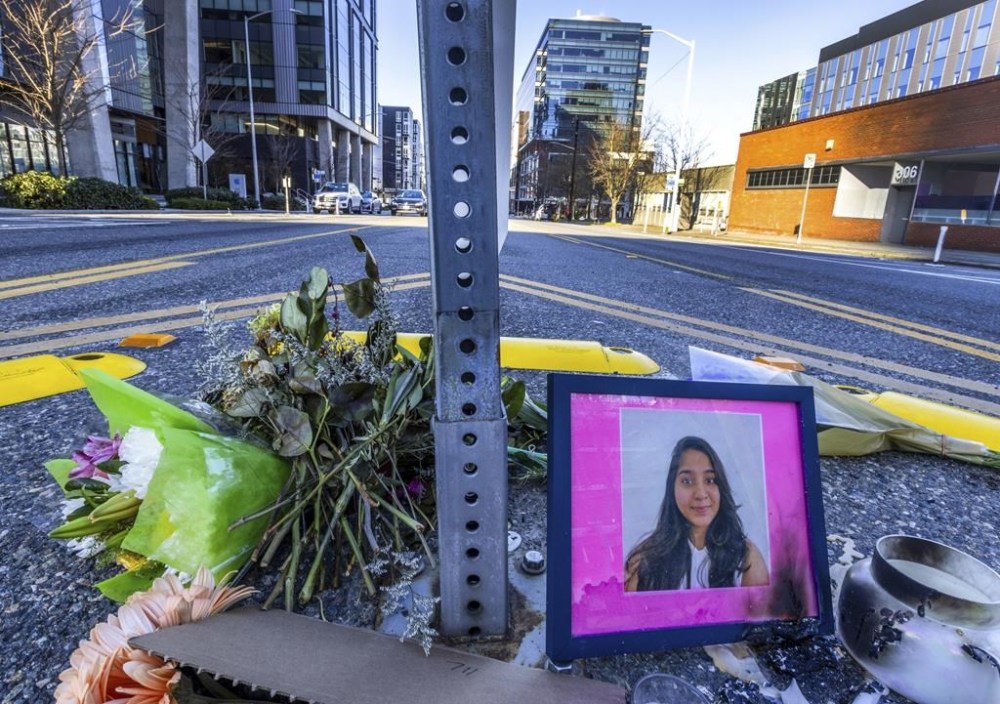 FILE - A photo of Jaahnavi Kandula is displayed with flowers, Jan. 29, 2023 in Seattle. A Seattle police officer has been fired for making callous remarks about the death of a graduate student from India after she was struck by another officer’s vehicle in a crosswalk last year. (Ken Lambert/The Seattle Times via AP, File)