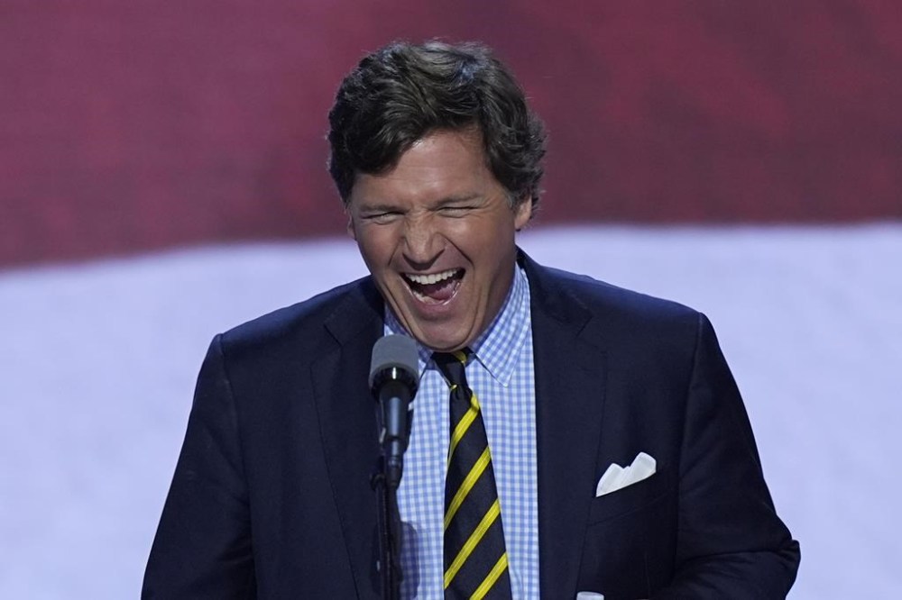 Tucker Carlson walks up to the podium to speak on the final day of the Republican National Convention on Thursday, July 18, 2024, in Milwaukee. (AP Photo/J. Scott Applewhite)