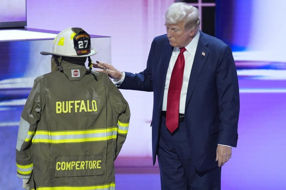 Republican presidential candidate former President Donald Trump standing next to the uniform of Corey Comperatore during the Republican National Convention Thursday, July 18, 2024, in Milwaukee. (AP Photo/J. Scott Applewhite)