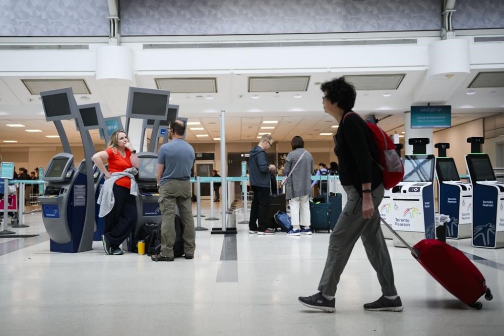 A global technology outage had grounded flights, disrupted hospitals and backed up border crossings in Canada on Friday, as reported issues persisted hours after the issues with Microsoft services were said to be getting fixed. Passengers are seen at Pearson International Airport, in Toronto, Saturday, June 29, 2024. THE CANADIAN PRESS/Christopher Katsarov”