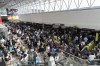 Travelers wait in line at Baltimore/Washington International Thurgood Marshall Airport in Baltimore, Friday, July 19, 2024. (AP Photo/Stephanie Scarbrough)