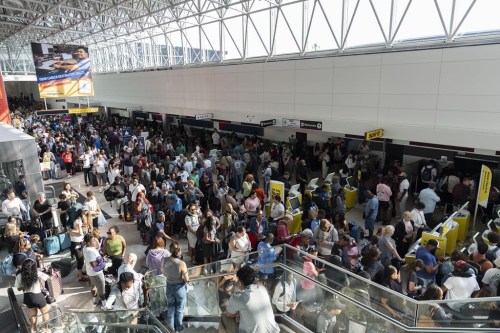 Travelers wait in line at Baltimore/Washington International Thurgood Marshall Airport in Baltimore, Friday, July 19, 2024. (AP Photo/Stephanie Scarbrough)