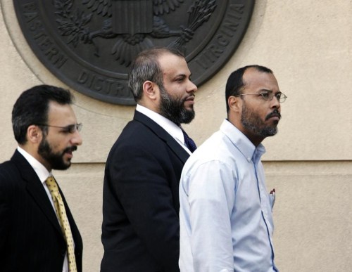 FILE - In this April 18, 2005 file photo, Ali Al-Tamimi, center, walks with two unidentified men, as he leaves the Albert V. Bryan Courthouse, in Alexandria, Va. A judge on Thursday, July 18, 2024, overturned a conviction carrying a life sentence for Al-Tamimi, who was found guilty of soliciting treason after the Sept. 11 attacks. (AP Photo/Manuel Balce Ceneta, File)
