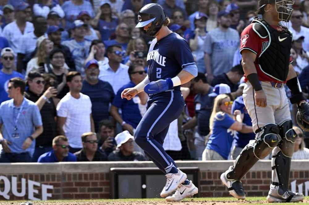 Chicago Cubs' Nico Hoerner scores during the eighth inning of a baseball game against the Arizona Diamondbacks, Friday, July 19, 2024, in Chicago. (AP Photo/Matt Marton)