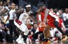 United States guard Jrue Holiday (12) and Canada guard Shai Gilgeous-Alexander (2) vie for the ball during the first half of an exhibition basketball game Wednesday, July 10, 2024, in Las Vegas. THE CANADIAN PRESS/AP-Steve Marcus