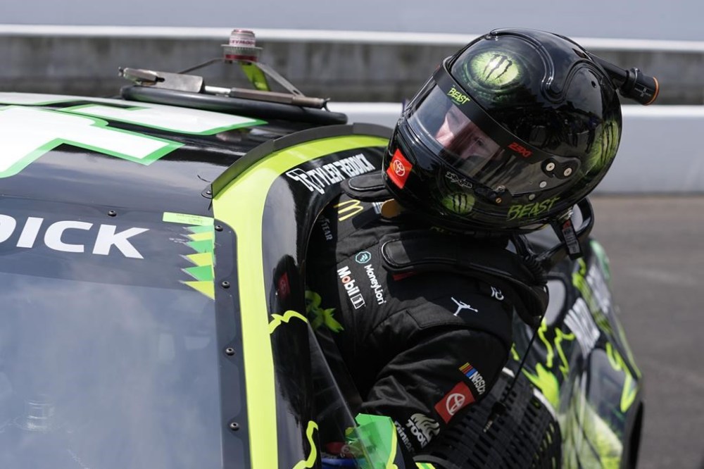 Tyler Reddick climbs out of his car after winning the pole for the NASCAR Cup Series auto race at Indianapolis Motor Speedway, Saturday, July 20, 2024, in Indianapolis. (AP Photo/Darron Cummings)