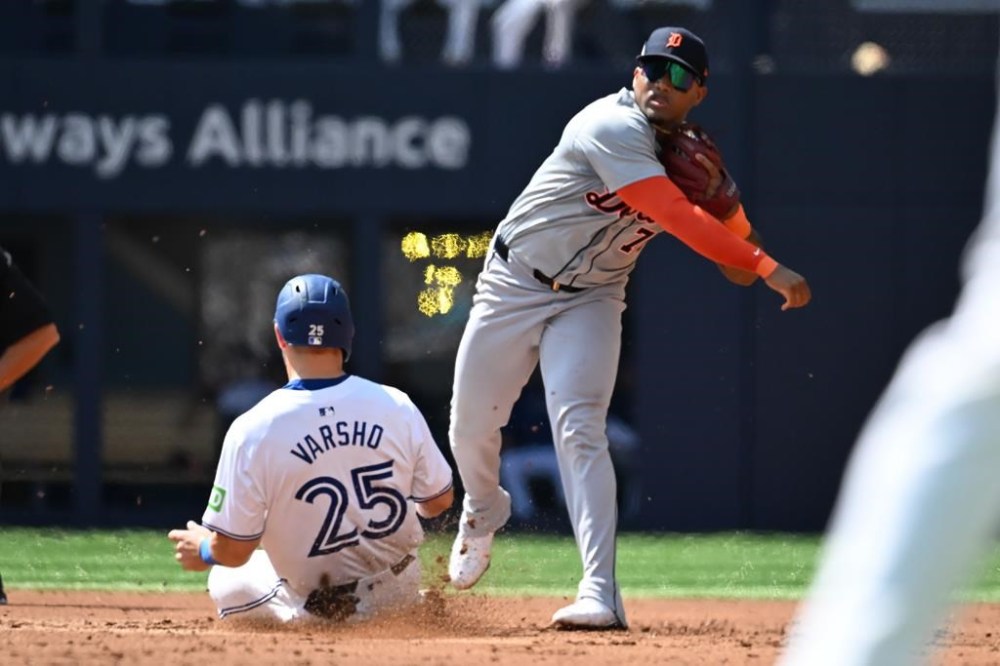 Detroit Tigers second baseman Andy Ibanez, right, throws to first base to complete a double play after forcing out Toronto Blue Jays right-fielder Daulton Varsho during second inning American League baseball action in Toronto on Saturday, July 20, 2024. THE CANADIAN PRESS/Jon Blacker