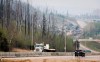 Traffic moves along Highway 63 as wildfire smoke hangs in air in Fort McMurray, Alta., on Wednesday, May 15, 2024. Wildfires in northern Alberta forced more people from their homes on Saturday while Edmonton offered masks to residents to help them deal with all the smoke. THE CANADIAN PRESS/Jeff McIntosh