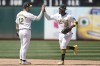 Oakland Athletics ' Max Schuemann (12) celebrates with Miguel Andujar (22) after they defeated the Los Angeles Angels in a baseball game in Oakland, Calif., Saturday, July 20, 2024. (AP Photo/Jeff Chiu)