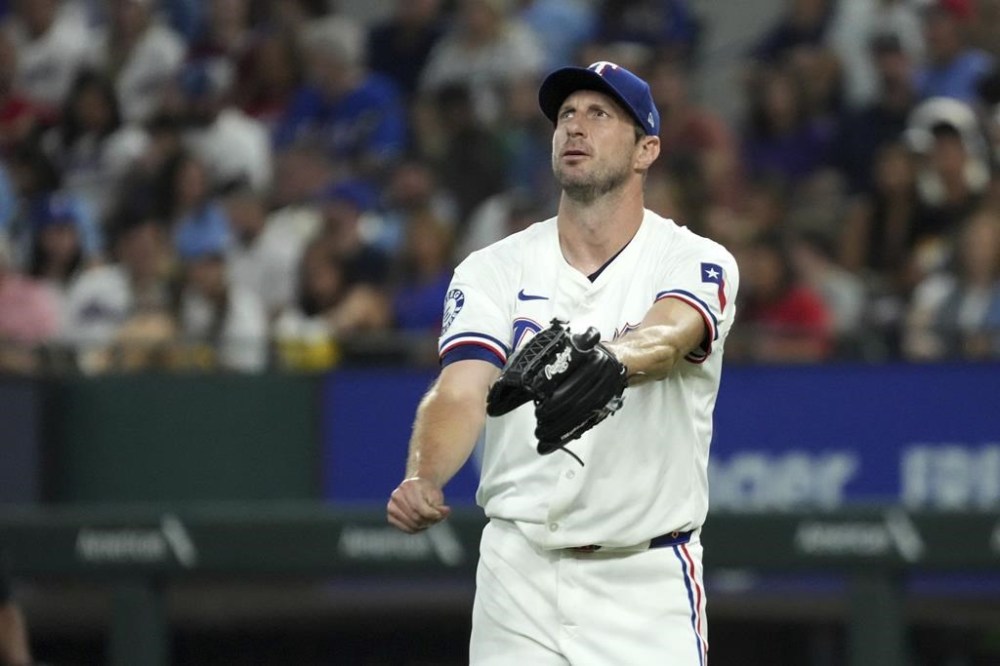 Texas Rangers starting pitcher Max Scherzer reacts after walking Baltimore Orioles' Ryan O'Hearn during the second inning of a baseball game, Saturday, July 20, 2024, in Arlington, Texas. The Orioles scored four runs in the inning. (AP Photo/Jeffrey McWhorter)