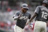 Washington Nationals' Harold Ramirez, left, celebrates after his two-run home run with Ricky Gutierrez (12) during the first inning of a baseball game against the Cincinnati Reds, Saturday, July 20, 2024, in Washington. (AP Photo/Nick Wass)