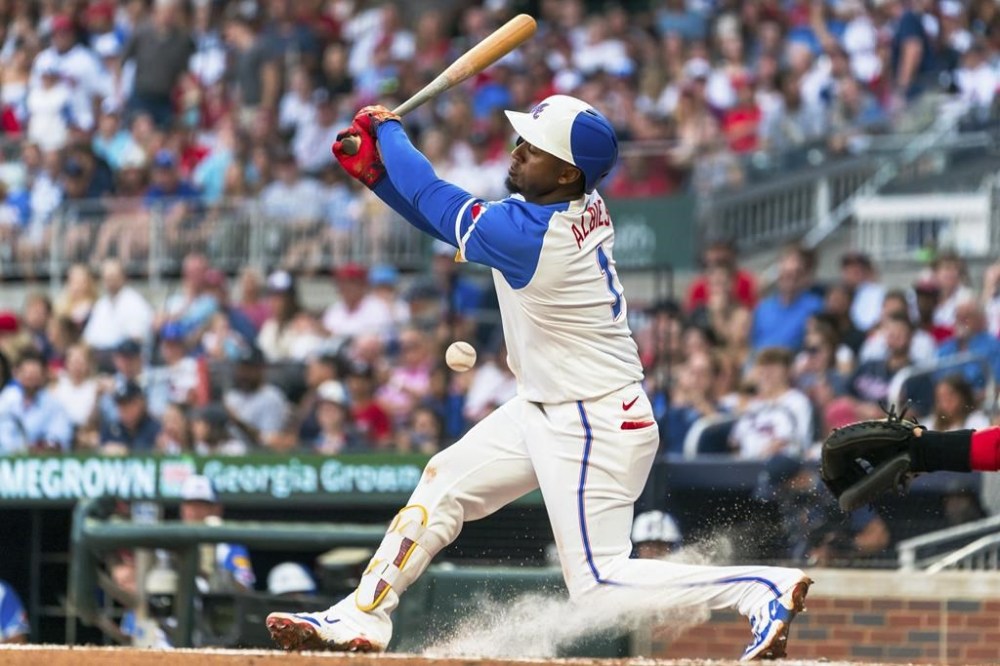 Atlanta Braves' Ozzie Albies hits in the third inning of the second baseball game of a doubleheader against the St. Louis Cardinals, Saturday, July 20, 2024, in Atlanta. (AP Photo/Jason Allen)