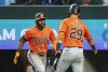 Baltimore Orioles' Cedric Mullins (31) is congratulated by Ramon Urias (29) after hitting a solo home run off of Texas Rangers relief pitcher Jose Urena during the third inning of a baseball game Saturday, July 20, 2024, in Arlington, Texas. (AP Photo/Jeffrey McWhorter)