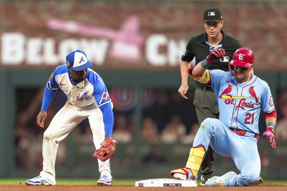 Atlanta Braves second baseman Ozzie Albies, left, attempts to tag out St.Louis Cardinals' Lars Nootbaar (21) who slides into second in the sixth inning of the second baseball game of a doubleheader Saturday, July 20, 2024, in Atlanta. (AP Photo/Jason Allen)