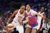 A'ja Wilson (9), of Team USA, drives past Dearica Hamby, front right, of Team WNBA, during the first half of a WNBA All-Star basketball game Saturday, July 20, 2024, in Phoenix. (AP Photo/Ross D. Franklin)