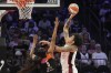 Brittney Griner (15), of Team USA, shoots over Angel Reese (5), of Team WNBA, during the second half of a WNBA All-Star basketball game Saturday, July 20, 2024, in Phoenix. (AP Photo/Ross D. Franklin)