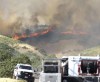 The Salt Lake City Fire Department, with help from other departments, prepares to battle a wildfire around Ensign Peak in Salt Lake City on Saturday, July 20, 2024. (Brice Tucker/The Deseret News via AP)