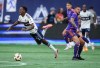 Vancouver Whitecaps' Ali Ahmed, left, is upended by Houston Dynamo's Artur during the first half of an MLS soccer match, in Vancouver, on Saturday, July 20, 2024. THE CANADIAN PRESS/Darryl Dyck