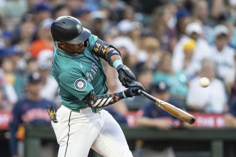 Seattle Mariners' Julio Rodriguez hits a two-run home run during the sixth inning of a baseball game against the Houston Astros, Saturday, July 20, 2024, in Seattle. (AP Photo/Stephen Brashear)