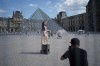 A woman from Mexico poses in the courtyard of the Louvre museum, which is outside the security perimeter set up for the Olympic Games, Friday, July 19, 2024, in Paris, France. (AP Photo/David Goldman)