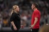 FILE - Cecile & Laurent Landi, coaches of Simone Biles, chat before she participates on the vault during the U.S. Gymnastics Championships, Sunday, June 2, 2024, in Fort Worth, Texas. The Landis are have a homecoming of sorts at the Paris Olympics when the French natives help lead Biles and a U.S. women's gymnastics team heavily favored to win gold. (AP Photo/Julio Cortez, File)