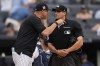 New York Yankees manager Aaron Boone, left, yells at umpire Edwin Jimenez, right, during the sixth inning of a baseball game against the Tampa Bay Rays at Yankee Stadium Sunday, July 21, 2024, in New York. Boone was ejected from the game. (AP Photo/Seth Wenig)