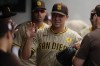 San Diego Padres pitcher Michael King is greeted in the dugout after the seventh inning of a baseball game against the Cleveland Guardians, Sunday, July 21, 2024, in Cleveland. (AP Photo/Sue Ogrocki)