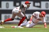 Cincinnati Reds second baseman Jonathan India, left, tags out Washington Nationals' Lane Thomas, right, who was attempting to steal second during the first inning of a baseball game Sunday, July 21, 2024, in Washington. (AP Photo/John McDonnell)