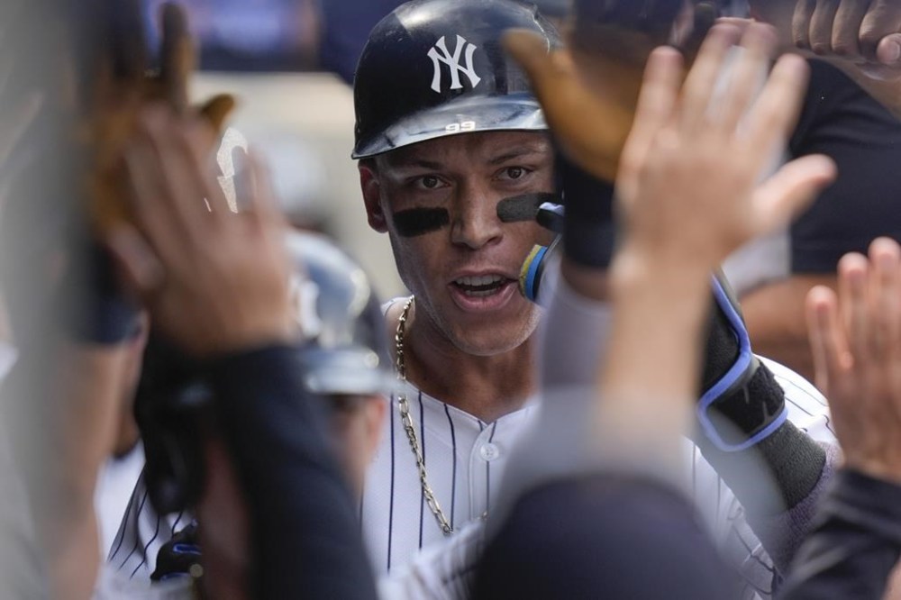 New York Yankees' Aaron Judge celebrates his three-run home run in the dugout during the seventh inning of the baseball game against the Tampa Bay Rays, Sunday, July 21, 2024, in New York. (AP Photo/Seth Wenig)