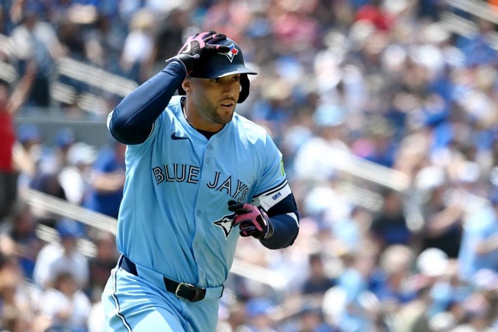 Toronto Blue Jays fielder George Springer (4) circles the bases after hitting a solo home run against the Detroit Tigers batter in first inning American League baseball action in Toronto on Sunday, July 21, 2024. THE CANADIAN PRESS/Jon Blacker