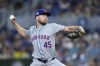 New York Mets' Christian Scott delivers a pitch during the first inning of a baseball game against the Miami Marlins, Sunday, July 21, 2024, in Miami. (AP Photo/Wilfredo Lee)