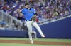 Miami Marlins third baseman Jake Burger throws to first to put out New York Mets' Francisco Lindor during the third inning of a baseball game, Sunday, July 21, 2024, in Miami. (AP Photo/Wilfredo Lee)