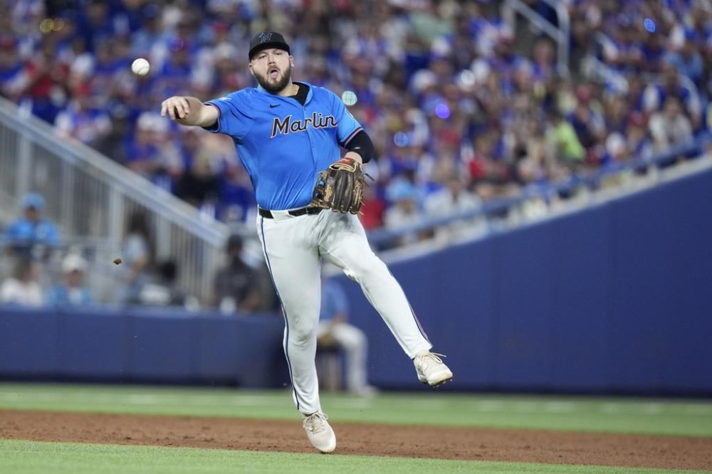 Miami Marlins third baseman Jake Burger throws to first to put out New York Mets' Francisco Lindor during the third inning of a baseball game, Sunday, July 21, 2024, in Miami. (AP Photo/Wilfredo Lee)