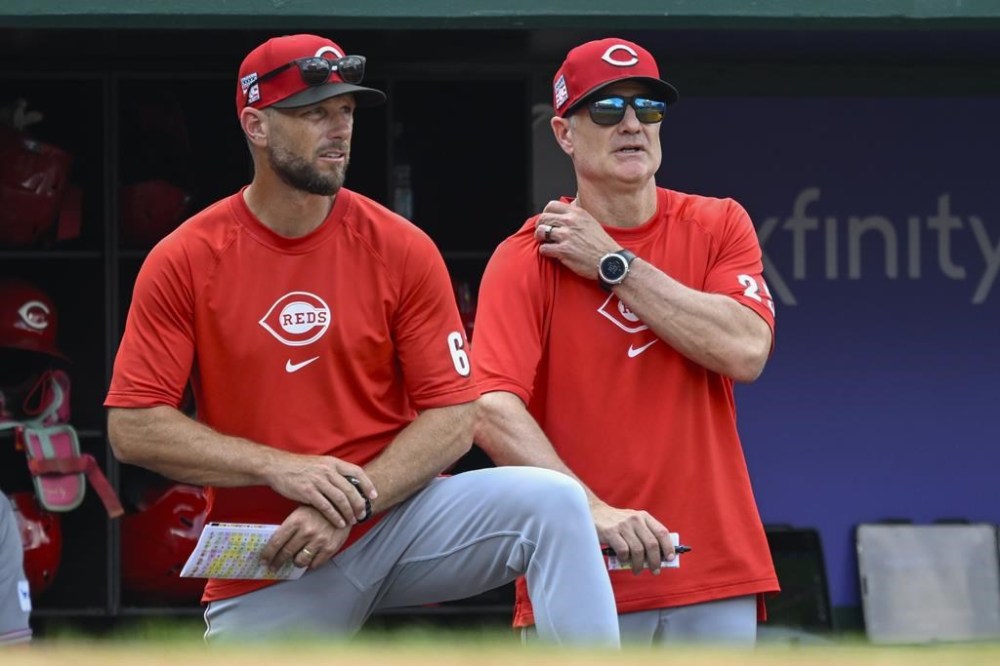 Cincinnati Reds bench coach Jeff Pickler, left, watches the Washington Nationals bat with Reds manager David Bell during the seventh inning of a baseball game against the Cincinnati Reds, Sunday, July 21, 2024, in Washington. (AP Photo/John McDonnell)