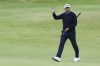 Daniel Brown of England gestures to the spectators as he walks to the 18th green during his final round of the British Open Golf Championships at Royal Troon golf club in Troon, Scotland, Sunday, July 21, 2024. (AP Photo/Scott Heppell)