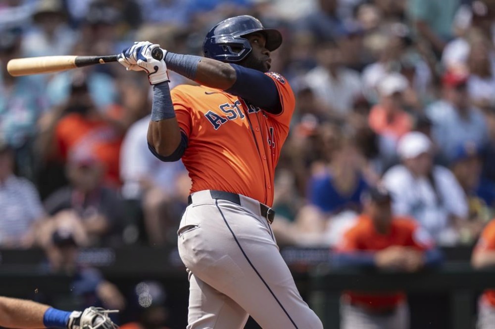 Houston Astros' Yordan Alvarez hits a one-run triple during the sixth inning of a baseball game against the Seattle Mariners, Sunday, July 21, 2024, in Seattle. (AP Photo/Stephen Brashear)