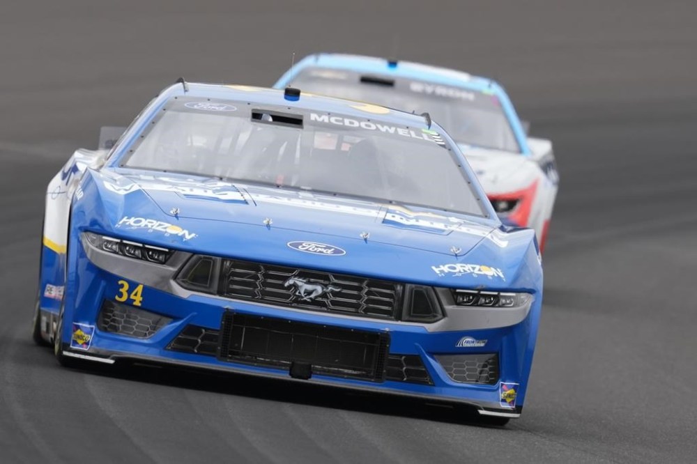 Michael McDowell drives into a turn during a NASCAR Cup Series auto race at Indianapolis Motor Speedway, Sunday, July 21, 2024, in Indianapolis. (AP Photo/Darron Cummings)