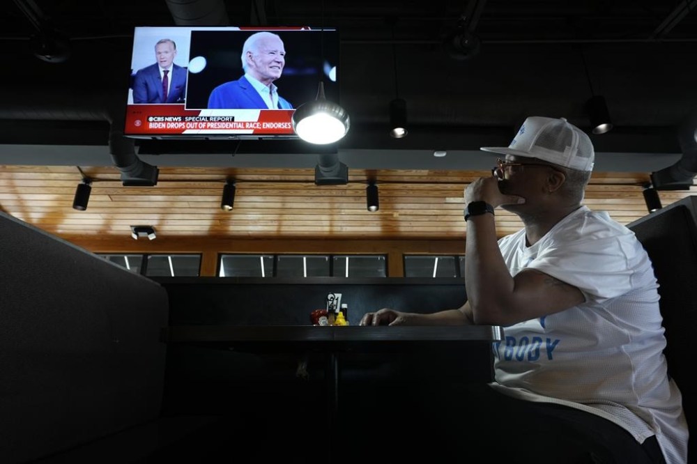 George Ledbetter watches news of President Joe Biden dropping out of the 2024 race for the White House at They Say Restaurant in Harper Woods, Mich., Sunday, July 21, 2024. (AP Photo/Paul Sancya)