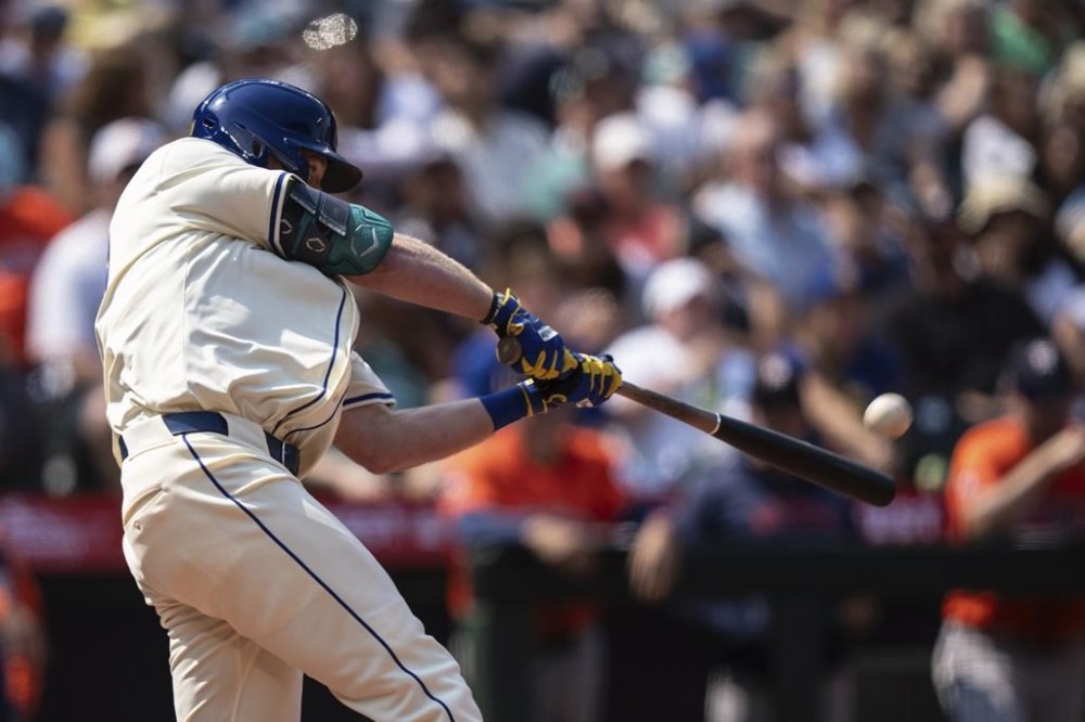 Seattle Mariners' Luke Raley hits a three-run home run during the sixth inning of a baseball game against the Houston Astros, Sunday, July 21, 2024, in Seattle. (AP Photo/Stephen Brashear)