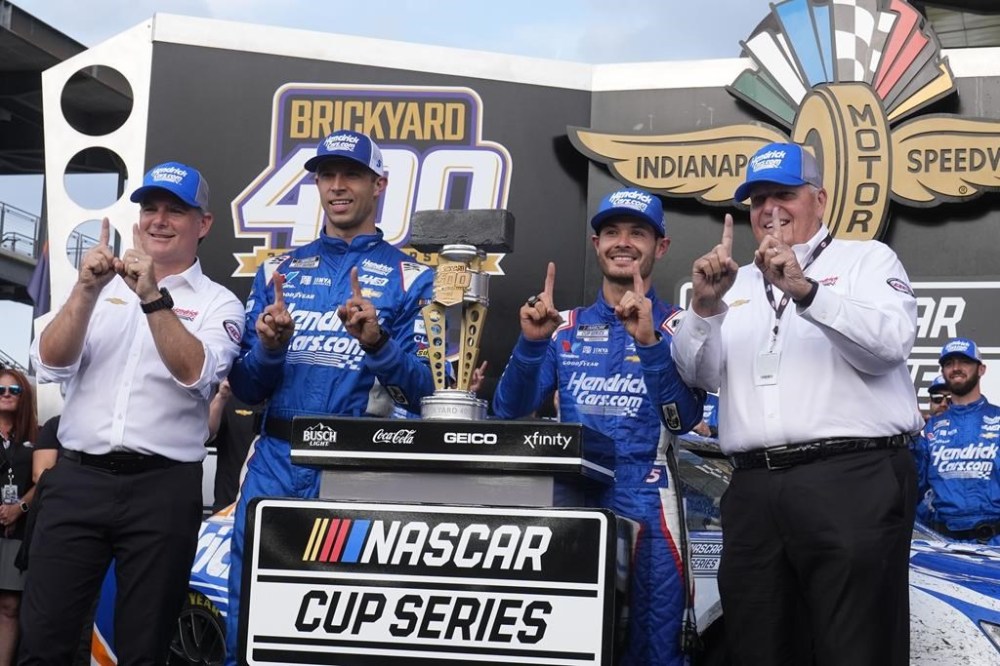 From left to right, Jeff Gordon, Cliff Daniels, Kyle Larson and Rick Hendrick celebrate after Larson won a NASCAR Cup Series auto race at Indianapolis Motor Speedway, Sunday, July 21, 2024, in Indianapolis. (AP Photo/Darron Cummings)