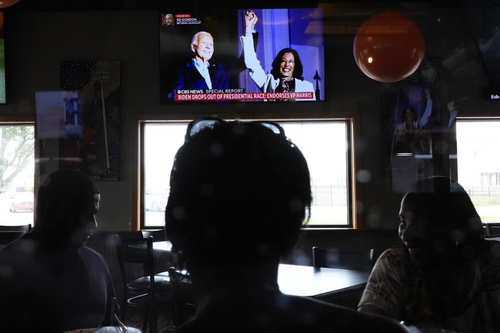 Diners watch news of President Joe Biden dropping out of the 2024 race for the White House at They Say Restaurant in Harper Woods, Mich., Sunday, July 21, 2024. (AP Photo/Paul Sancya)