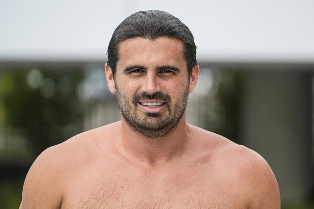 U.S. Men's Olympic Water Polo team captain Ben Hallock pauses for a picture after a training session for the 2024 Paris Olympics at Mt. San Antonio College in Walnut, Calif., on Wednesday, Jan. 17, 2024. The American captain hopes to lead the U.S. men to the program's first podium finish since it won silver in 2008. (AP Photo/Damian Dovarganes)