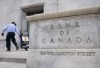 A new report says the Bank of Canada's recent interest rate cut did little to change Canadians' negative perceptions about their personal finances. A worker rolls signs past the Bank of Canada, Wednesday, April 10, 2024 in Ottawa. THE CANADIAN PRESS/Adrian Wyld