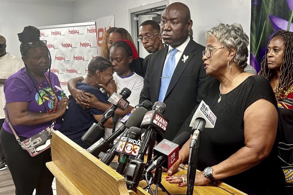 Illinois state Sen. Doris Turner, D-Springfield, speaks to reporters while family members of Sonya Massey comfort one another in Springfield, Ill. on Monday, July 22, 2024. A former Sangamon County sheriff's deputy has been charged with murder after shooting Massey inside her home while responding to a 911 call on July 6. (AP Photo/John O'Connor)